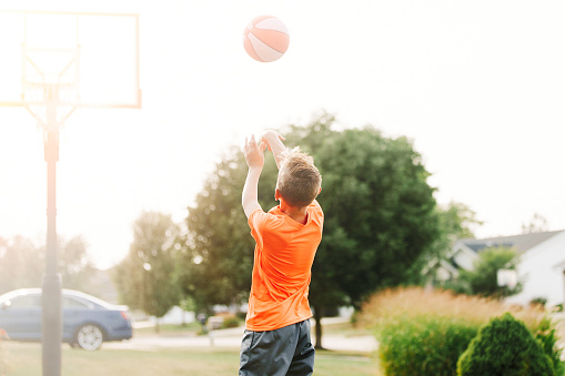 Boy shooting a basketball