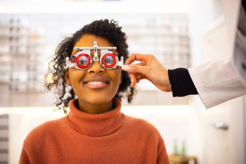 Woman smiling with examination glasses on her eyes.