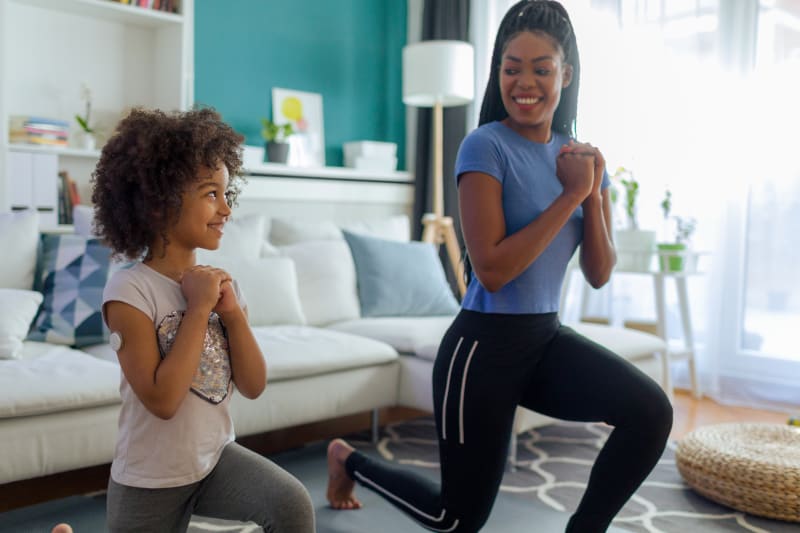 Mother and young Daughter exercising together.