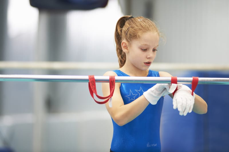 A young girl participates in gymnastics.