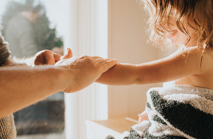 Child showing parent their arm after bath 