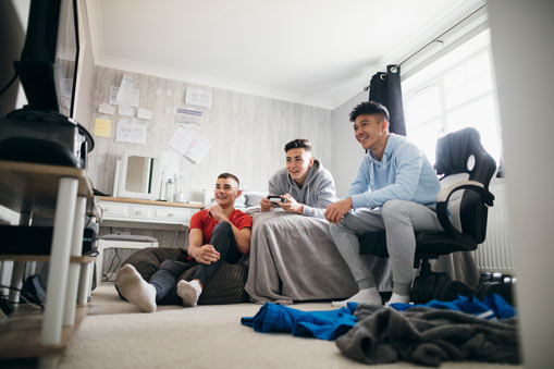 Group of teenage boys playing video games.