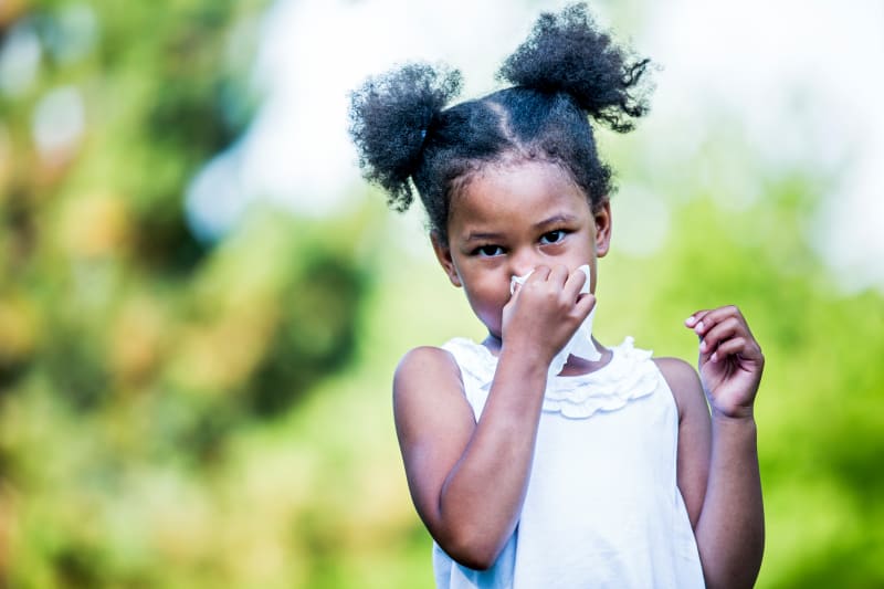 Child with tissue for their nose