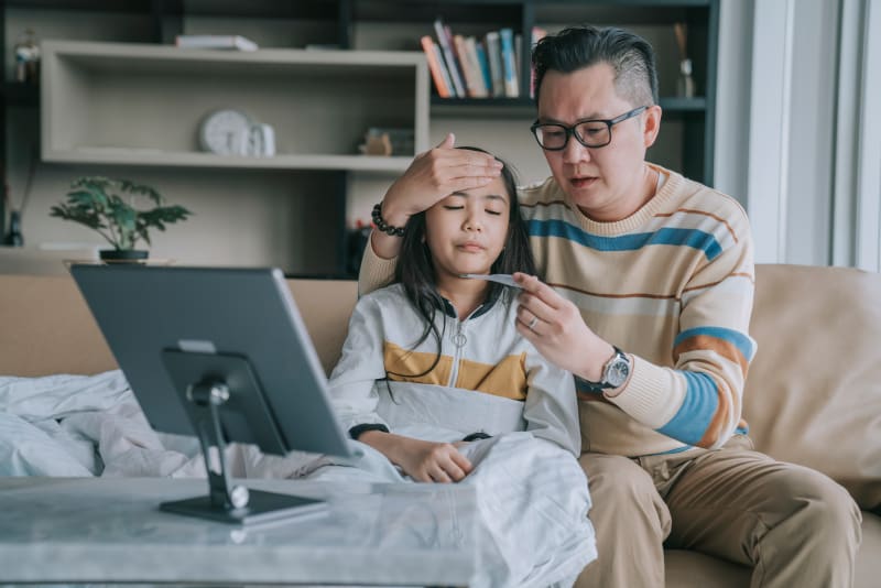 Father checking child's temperature.