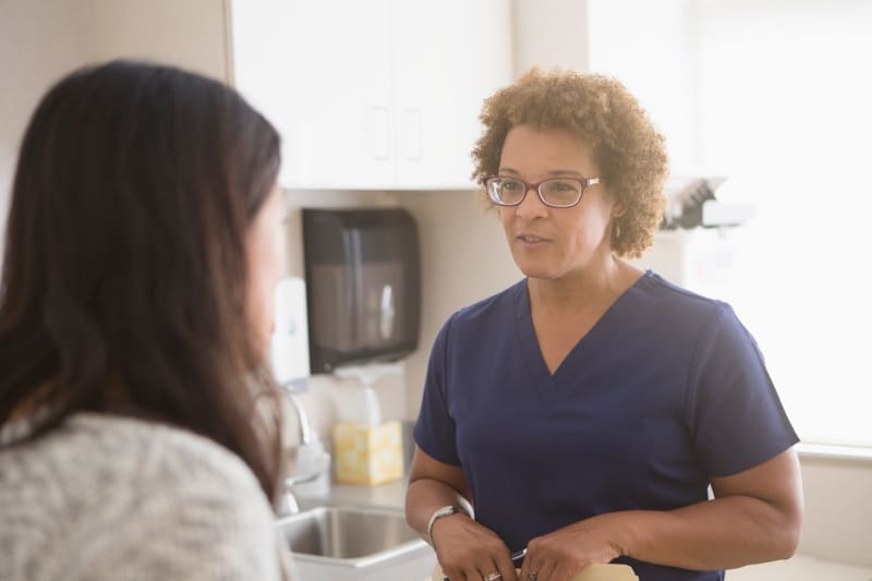 Young woman talking to her doctor at a women's health appointment. 