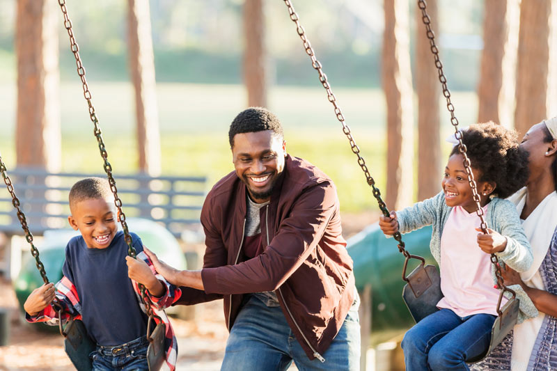 Family having fun on the swings.